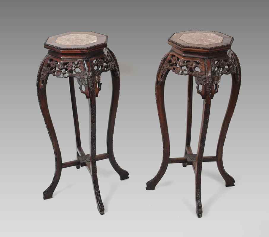 Appraisal: PAIR CHINESE CARVED ROSEWOOD MARBLE TOP STANDS Octagonal top with