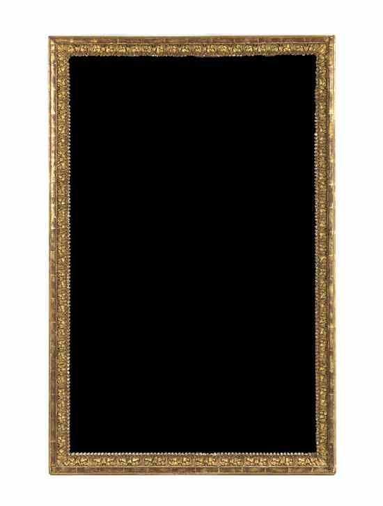 Appraisal: A Continental Giltwood Mirror the rectangular frame having repeating carved