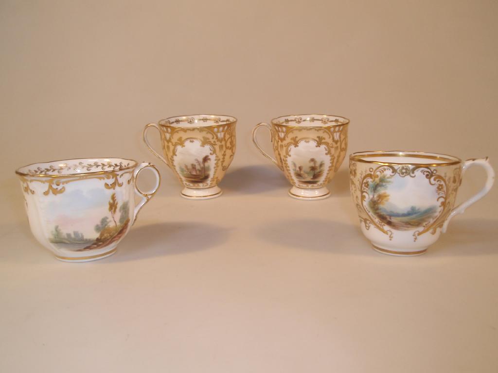 Appraisal: Four thC porcelain tea cups each painted with landscape vignettes