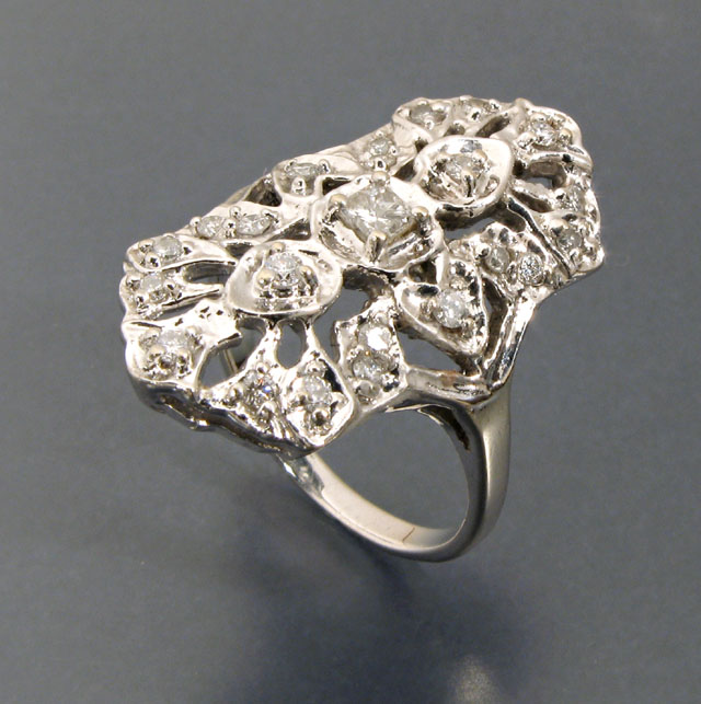 Appraisal: DIAMOND AND FOURTEEN KARAT WHITE GOLD RING the openwork cigar