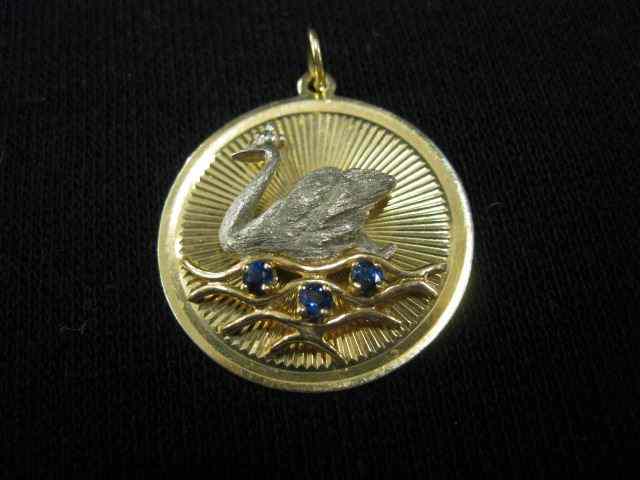 Appraisal: k Gold Charm figural swan with trio ofblue sapphires on