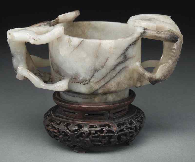 Appraisal: Chinese Ming carved jade libation cup with two dragon handles