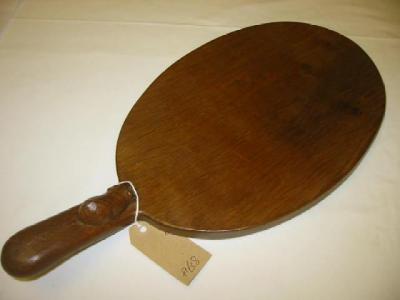 Appraisal: AN ADZED OAK CHEESEBOARD by Robert Mouseman Thompson of oval