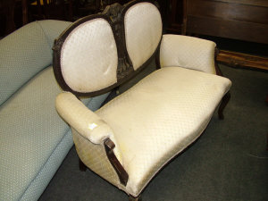 Appraisal: An Edwardian beige upholstered settee the shaped padded back with