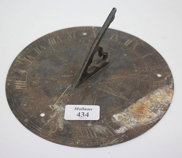 Appraisal: A CIRCULAR BRASS SUNDIAL PLATE with pierced gnomen