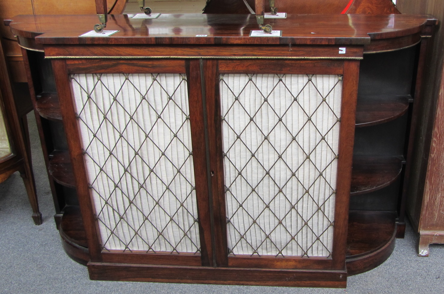 Appraisal: A th century bowfront side cabinet with pair of cupboard