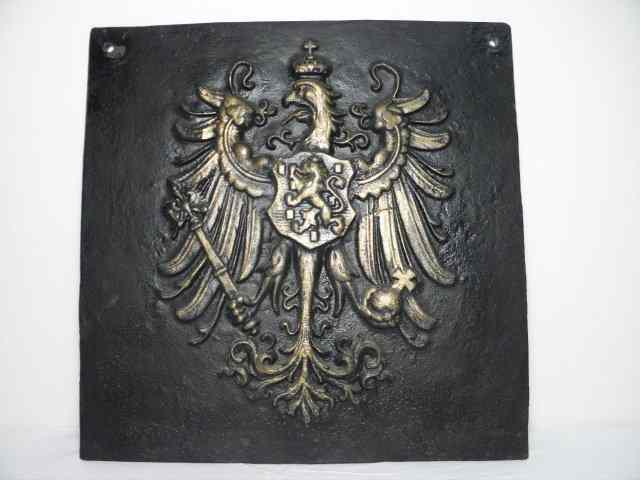 Appraisal: Cast iron fireplace backing with a coat of arms in