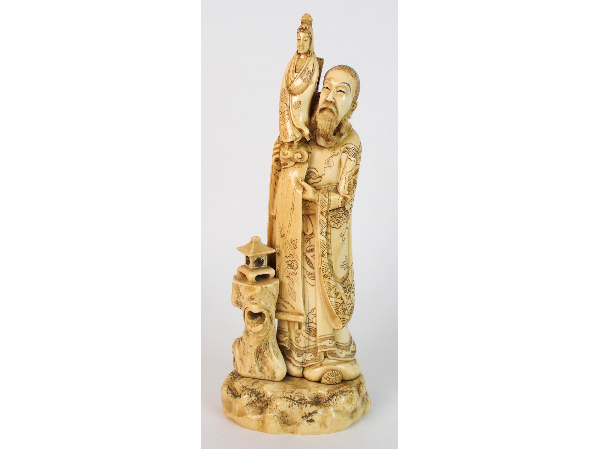 Appraisal: A Japanese ivory okimono of Kannonraised on the shoulder of