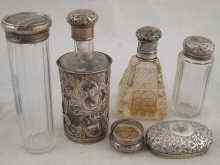 Appraisal: A mixed lot comprising three silver topped dressing table jars