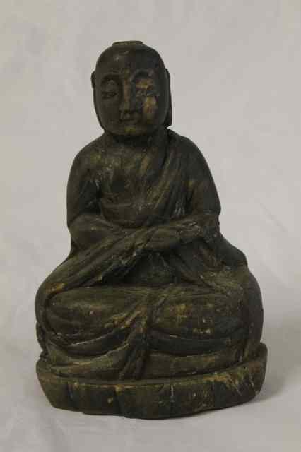 Appraisal: A JAPANESE MINGEI CARVED FIGURE OF A SEATED BUDDHA possibly