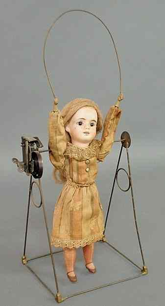 Appraisal: French bisque head automation doll jumping rope with metal arms