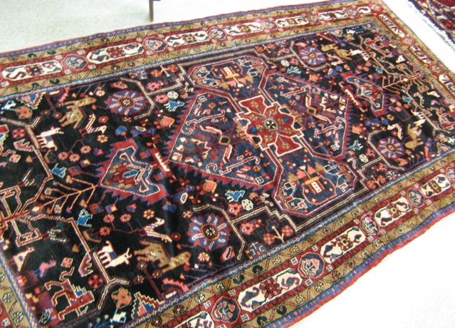 Appraisal: PERSIAN TRIBAL CARPET central geometric medallion and surrounding stylized floral