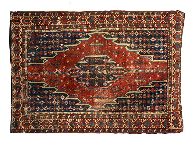 Appraisal: A MAZLAGHAN RED GROUND RUG with central angular stylised design