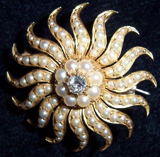 Appraisal: A sunburst metamorphic brooch pendant set a central diamond to