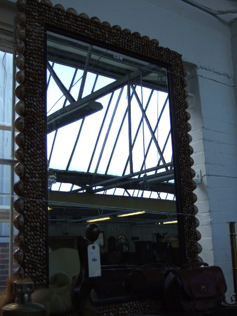 Appraisal: A large rectangular mirror applied with a wide border of