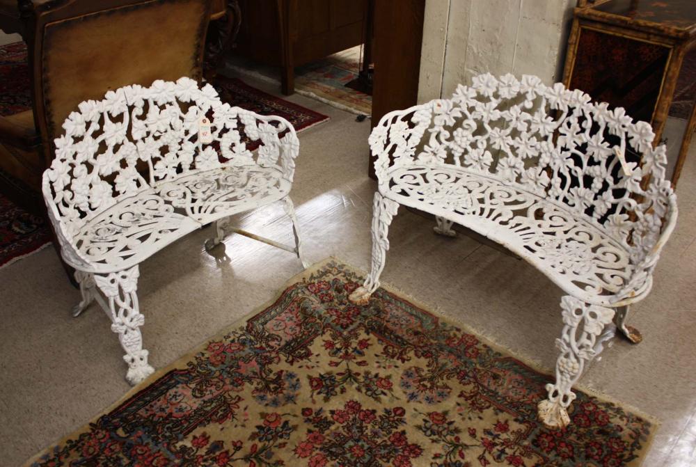 Appraisal: TWO SIMILAR WHITE METAL GARDEN SETTEES the larger version of