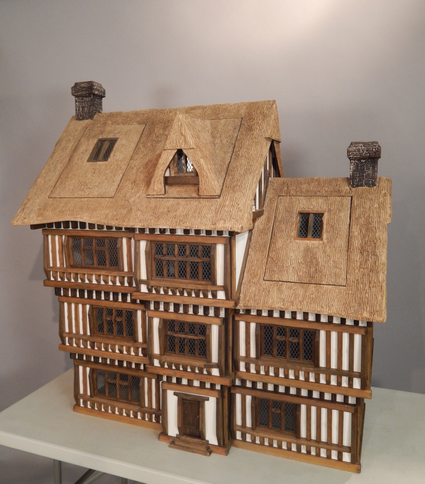 Appraisal: A large three storey simulated thatch and timber framed dolls