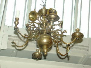 Appraisal: A Dutch style brass six branch chandelier fitted with scrolled