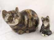 Appraisal: A ceramic seated brindled cat with glass eyes cm long