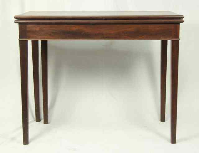 Appraisal: A Georgian mahogany tea table with folding top on square