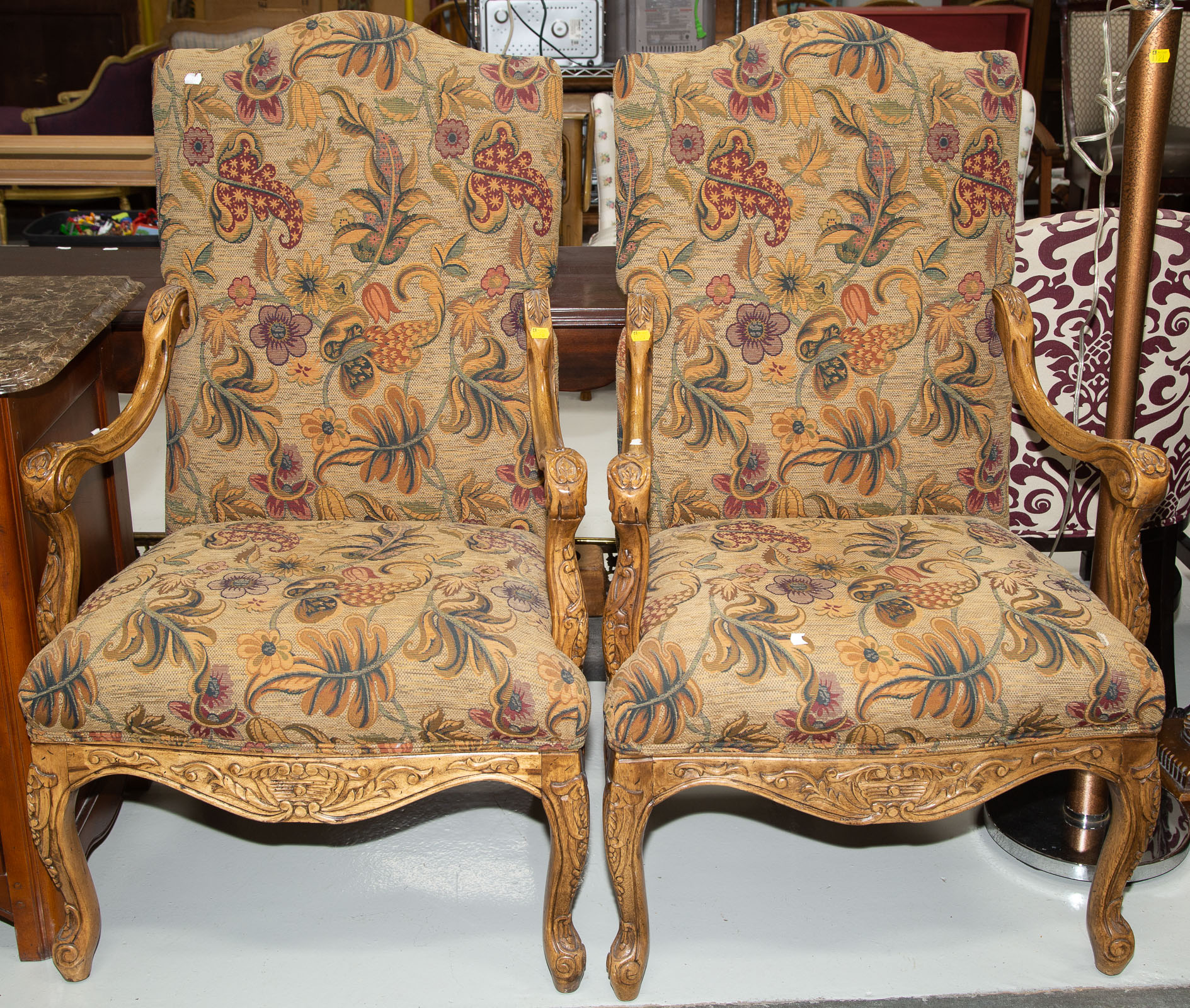 Appraisal: A PAIR OF FRENCH PROVINCIAL CARVED WOOD ARMCHAIRS Contemporary with