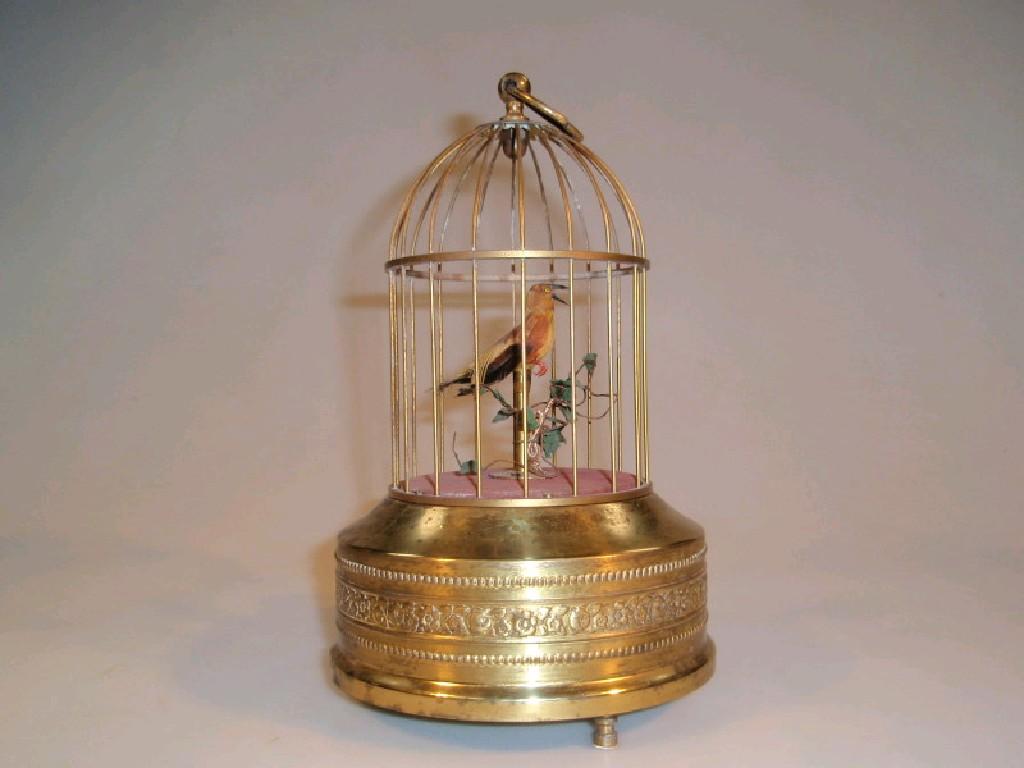 Appraisal: A gilt metal automaton bird in a cage cm high