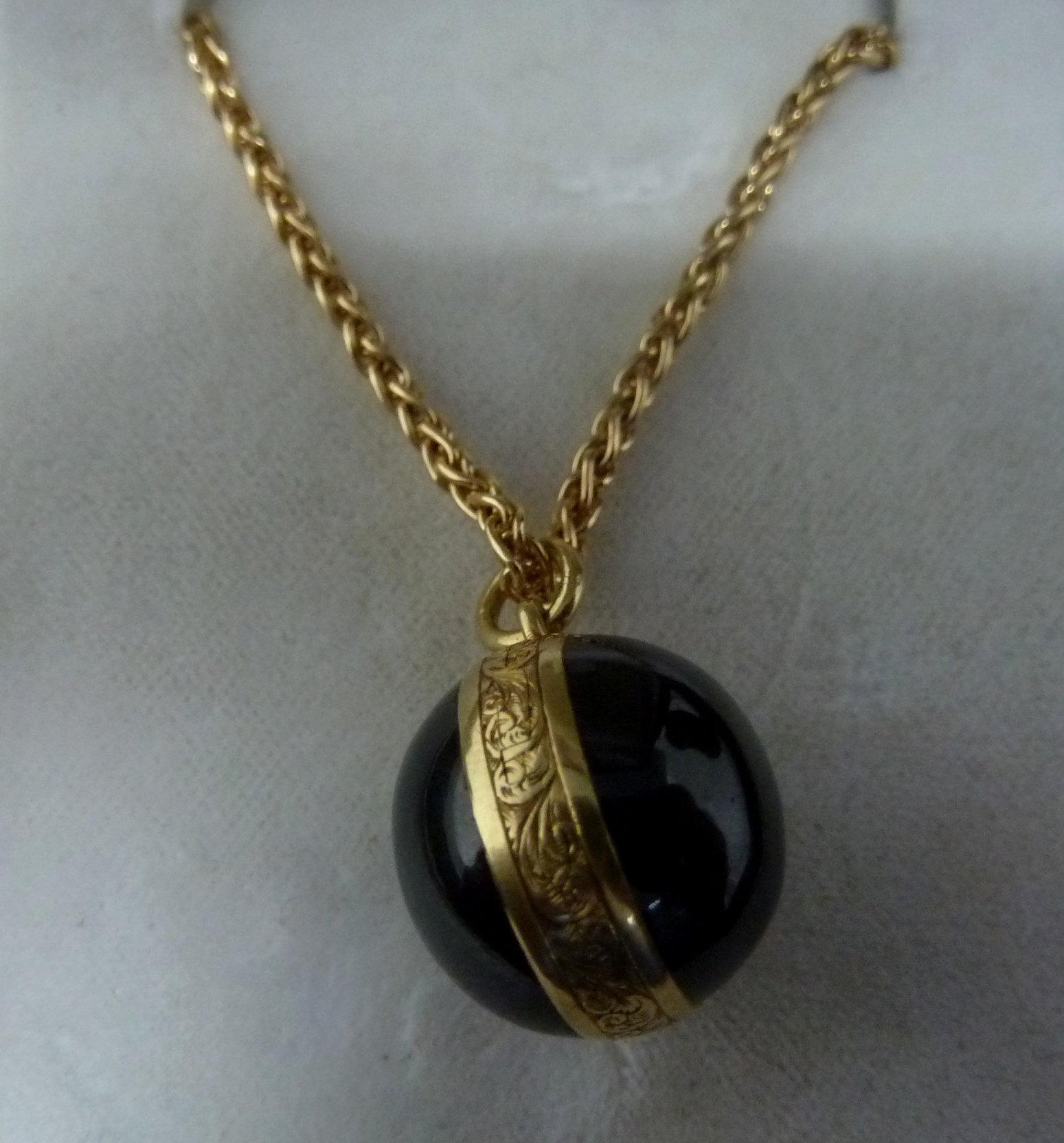 Appraisal: A Victorian garnet locket of globe form enclosing a locket