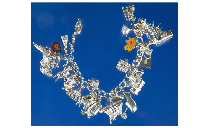 Appraisal: Silver Charm Bracelet Loaded With Charms Comprising Cart Parrot Beer