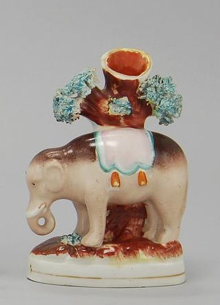 Appraisal: STAFFORDSHIRE ELEPHANT-FORM SPILL HOLDER Circa With tree trunk and cole