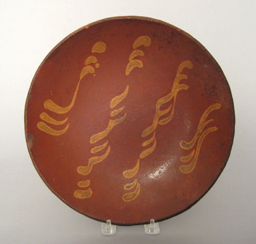 Appraisal: Redware pie plate th c with yellow slip decoration dia