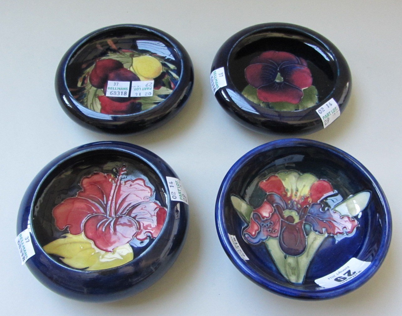 Appraisal: Four Moorcroft blue ground pottery dishes early mid th century