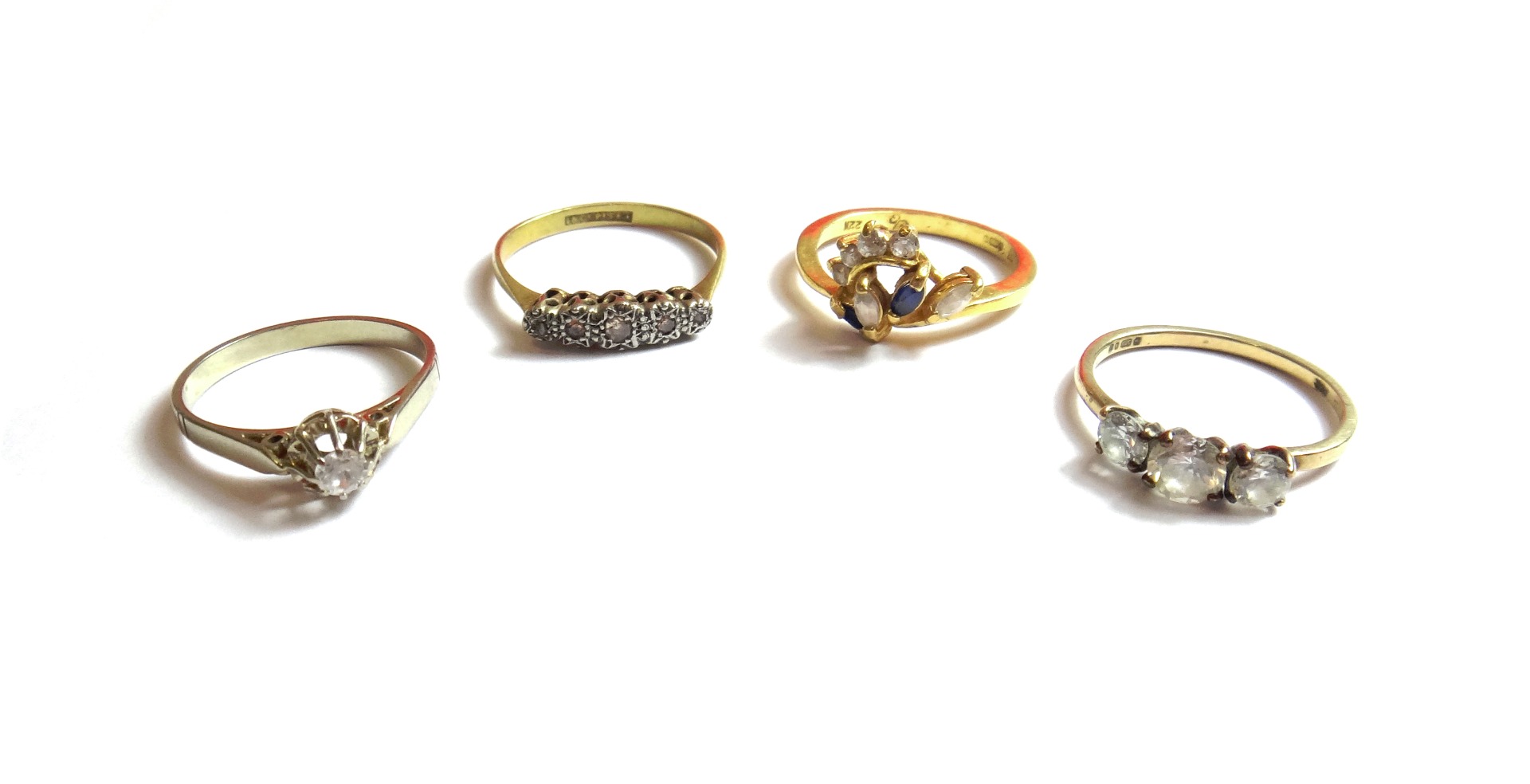 Appraisal: A gold and platinum diamond set five stone ring a