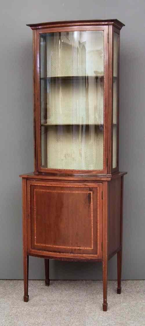 Appraisal: An Edwardian mahogany bow-front display cabinet inlaid with satinwood bandings