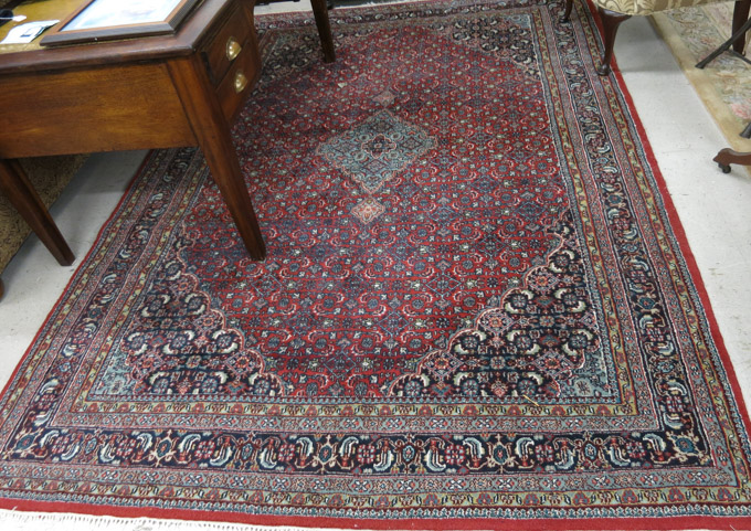 Appraisal: HAND KNOTTED ORIENTAL CARPET Indo-Bijar central medallion and Herati floral