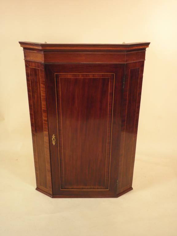 Appraisal: An early thC mahogany and boxwood strung hanging corner cabinet