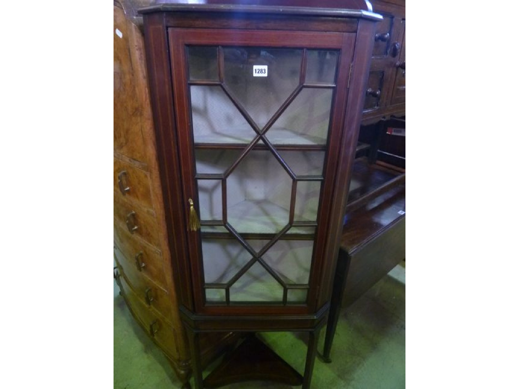 Appraisal: A small inlaid Edwardian mahogany freestanding corner display cabinet enclosed