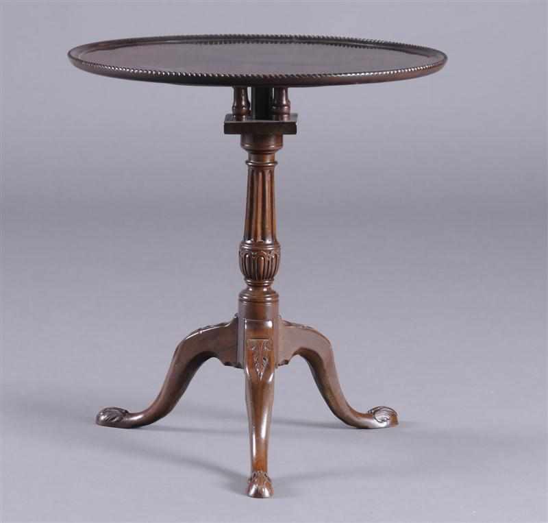 Appraisal: GEORGE III CARVED MAHOGANY TRIPOD TEA TABLE The circular tilting