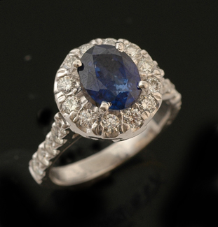 Appraisal: A sapphire and diamond cluster ring The oval cut sapphire