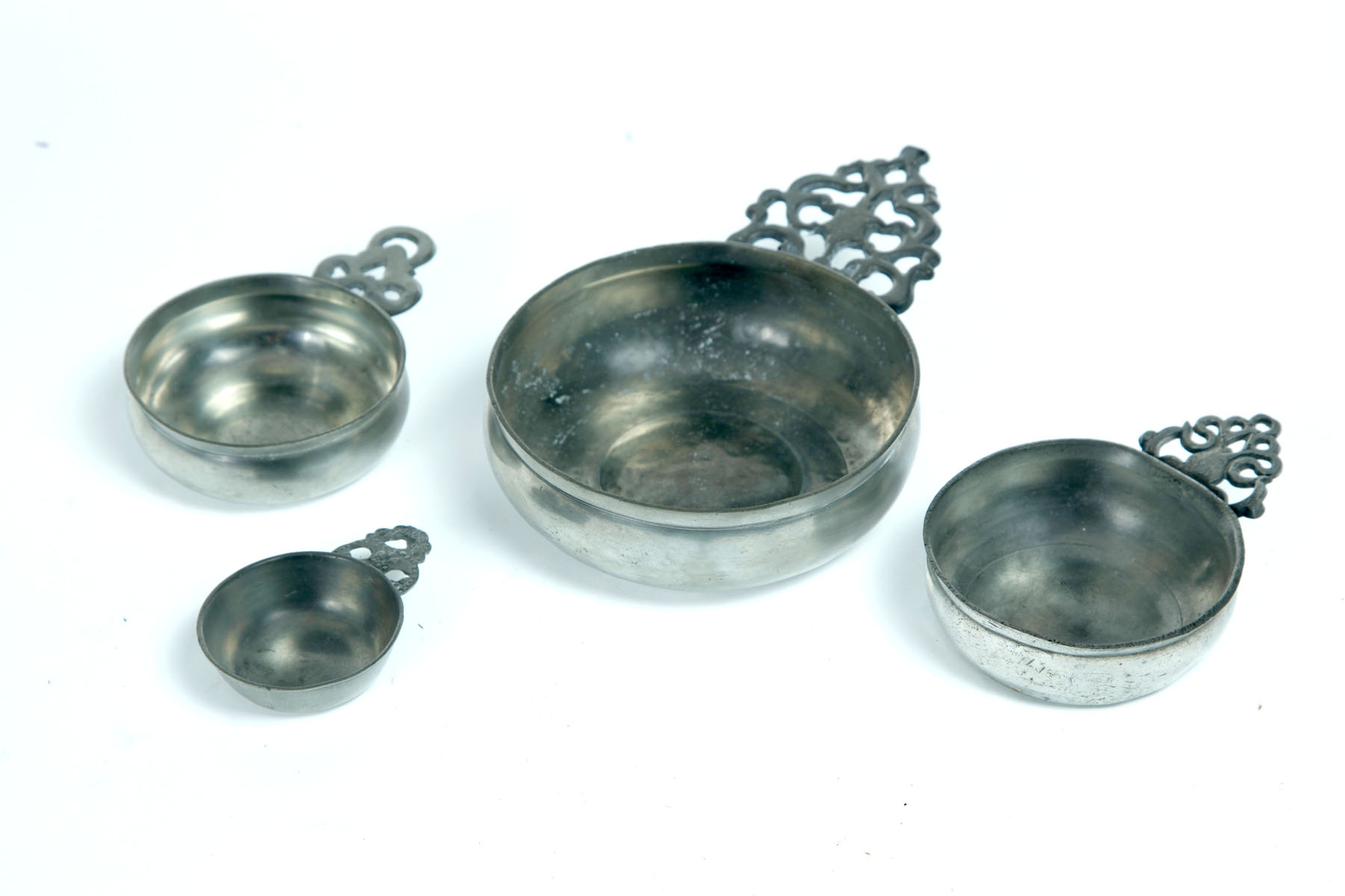 Appraisal: FOUR PEWTER PORRINGERS American st half- th century Old English-type