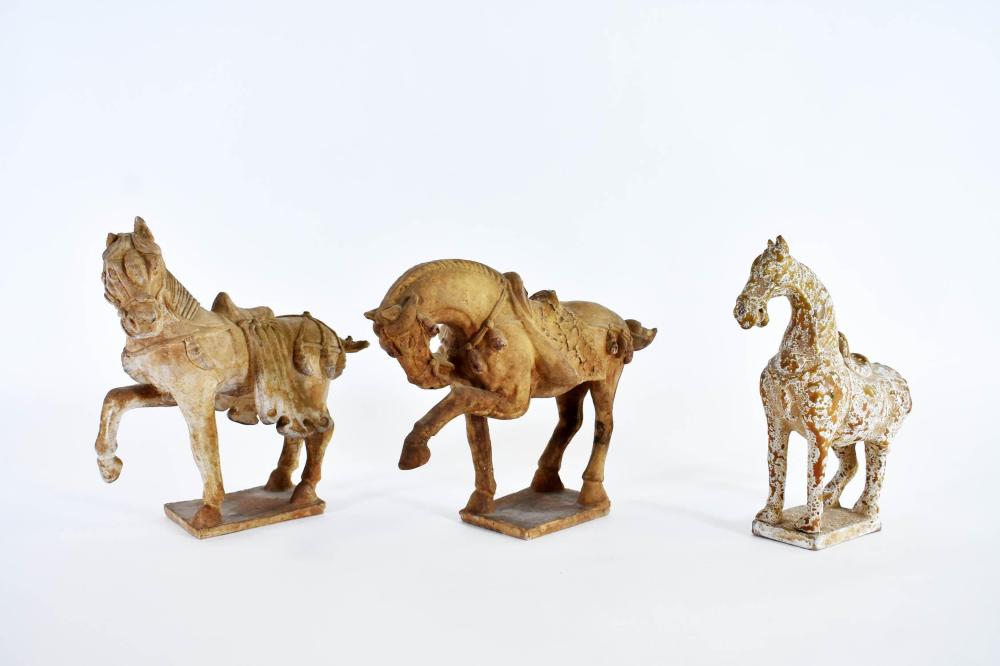 Appraisal: THREE CHINESE TANG STYLE EARTHENWARE HORSESComprised of a pair and