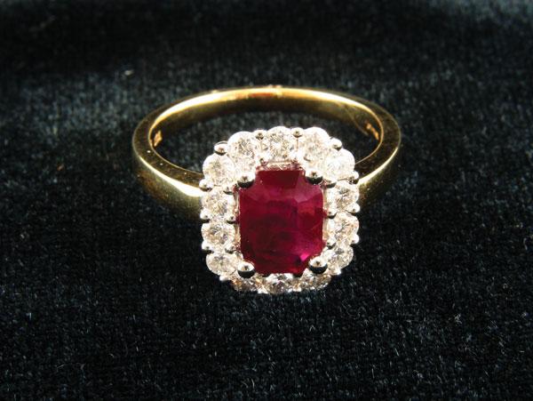 Appraisal: A Contemporary Ruby and Diamond Ring claw-set with step-cut ruby