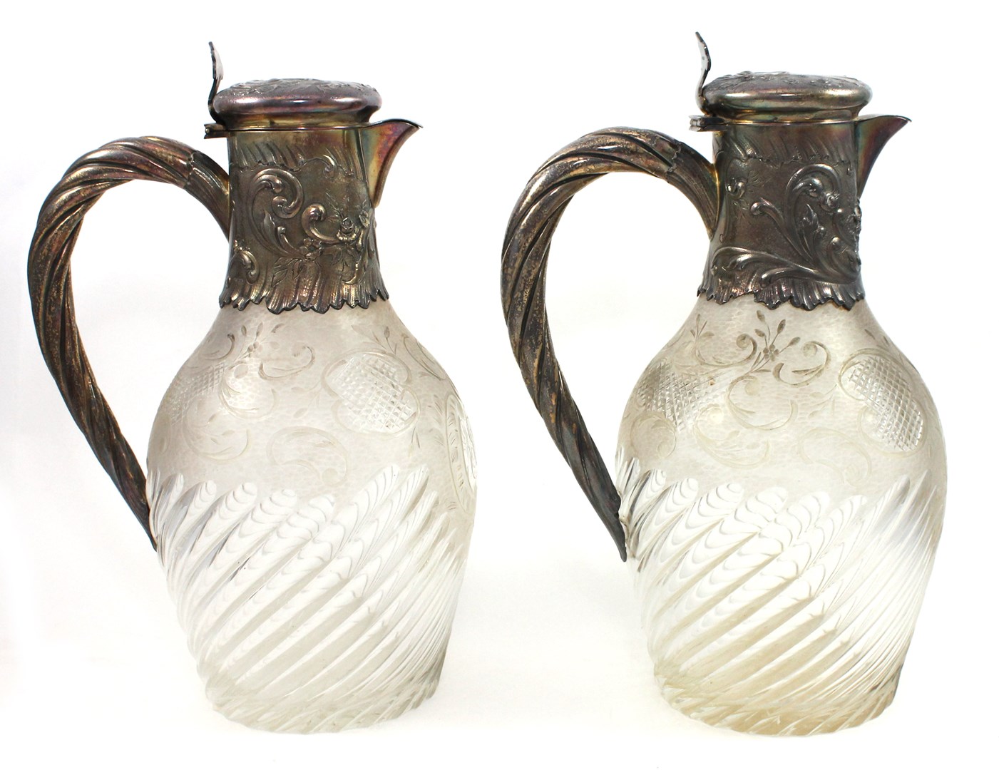 Appraisal: A pair of French silver gilt mounted glass claret jugs