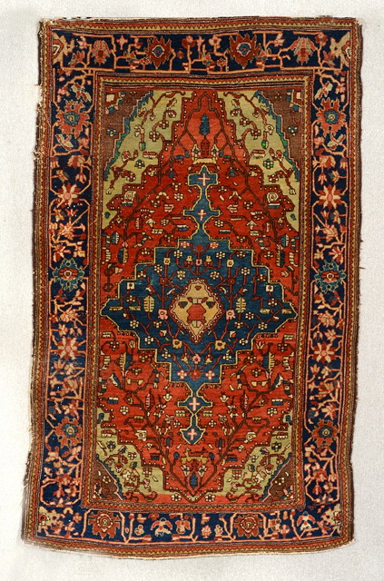 Appraisal: A SAROUK RED GROUND RUG decorated a central blue ground