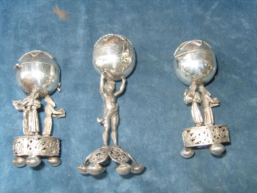 Appraisal: A collection of three Russian silver stylised pepper pots showing