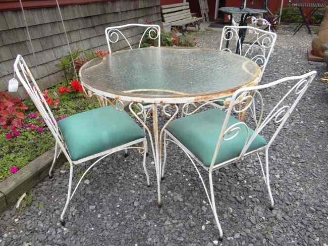 Appraisal: Wrought iron glass top patio table with four chairs