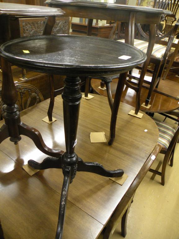 Appraisal: An ebonised occasional table with a dish top the base