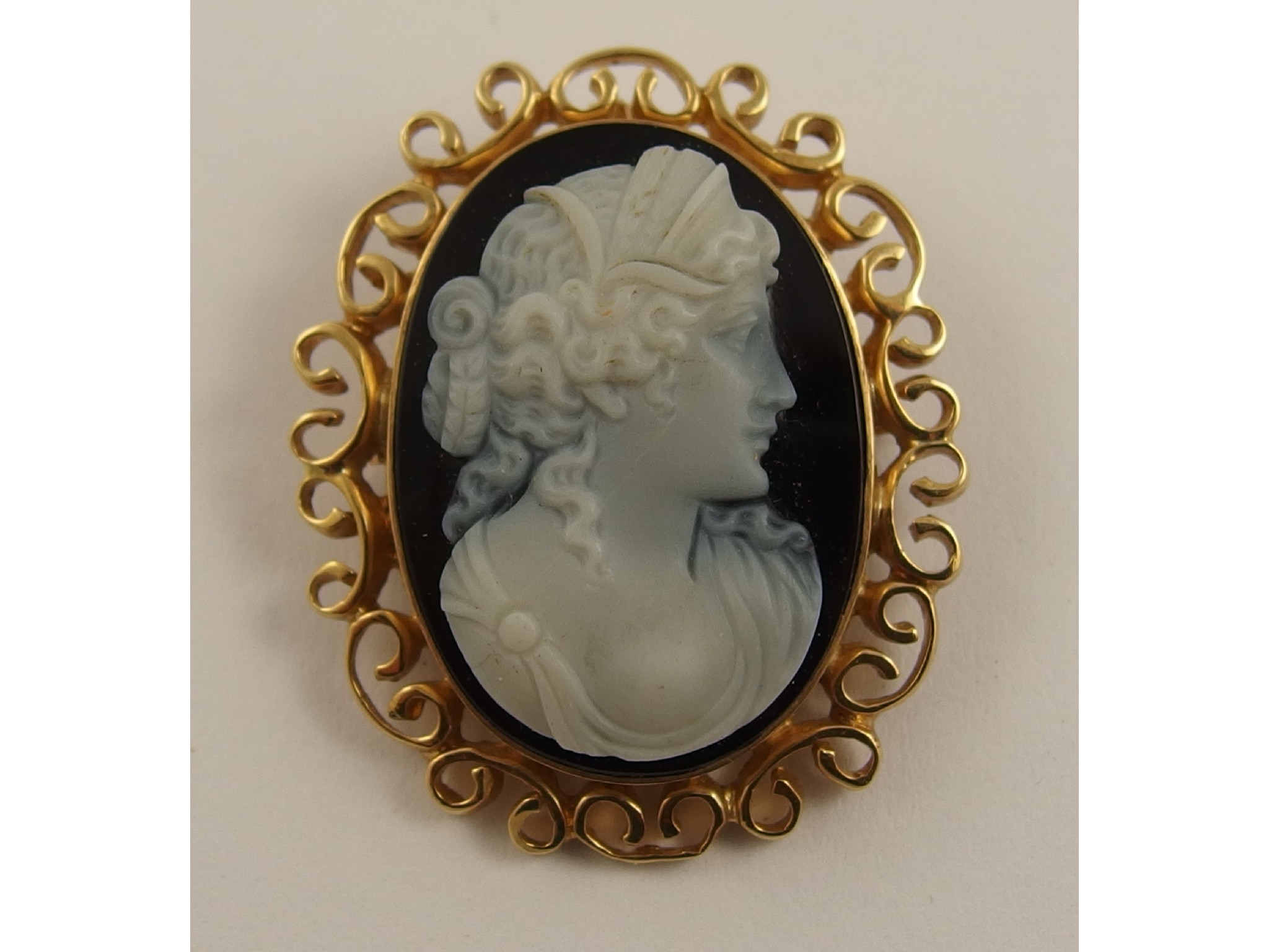 Appraisal: A ct black and white hardstone cameo pendant broochdepicting a