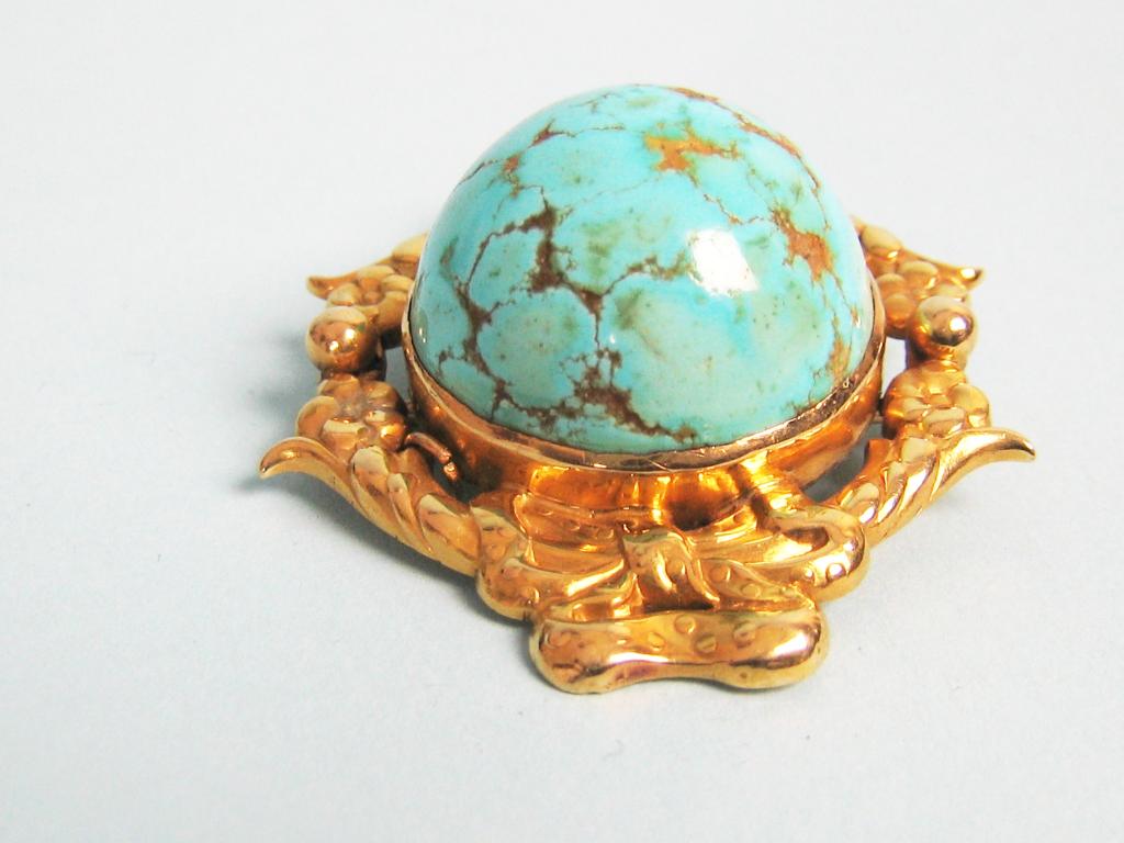 Appraisal: A Tiffany Turquoise Brooch the large cabochon stone collet-set within