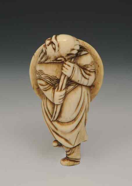 Appraisal: A CARVED IVORY NETSUKE in the form of a recumbent