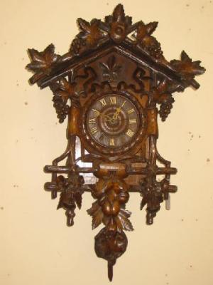 Appraisal: A BLACK FOREST WALL CLOCK the two train movement striking